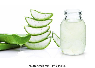 Close up bottle of Aloe Vera essential oil extract with Aloevera leaf and cut slice isolated on white background. Skin care, health, beauty and spa concept.
