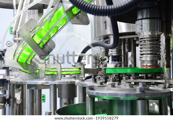 Close up bottle caps in a rail\
feeding to capping machine in beverage manufacturing process. Food\
and industrial concept. Automation technology in\
factory.