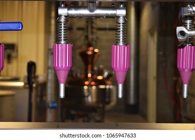 Close Up Of Bottling Spouts In Gin Distillery