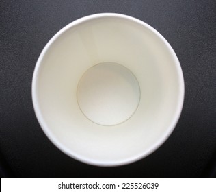 close up bottom of empty recycle paper cup on dark background texture
