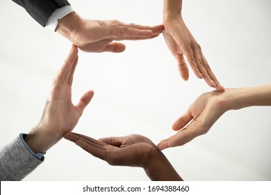 Close up bottom view concept of diverse business people join hands forming circle. Show unity and support, protection of business. Multiracial colleagues involved in team building activity.