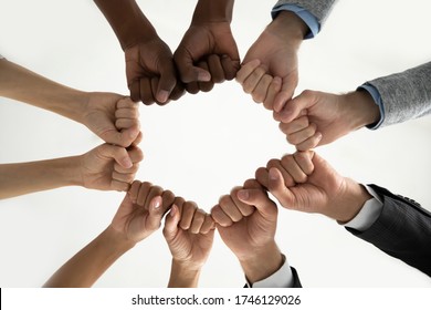 Close Up Bottom View Diverse Employees Team Holding Fists In Circle, Expressing Unity And Power In Teamwork, Multiethnic Business People Engaged In Team Building Activity At Briefing