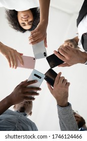 Close Up Bottom View Diverse People Using Phones, Standing In Circle, Employees Holding Smartphones In Hands, Looking Down At Screen, Social Media Addiction, Chatting, Shooting Video Or Photo