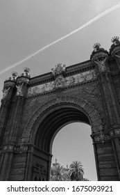 Close Up Bottoms Up High Contrast Abstract Black And White Photograph Of Arc De Triomf, Barcelona, Spain. The Vantage Point And The Clouds Cutting Through The Frame Give A Interesting Artistic Look. 