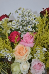 Close Up Bouquet Of Flowers Has Red Pink And Orange Rose With Small White Flowers And Yellow Grass 