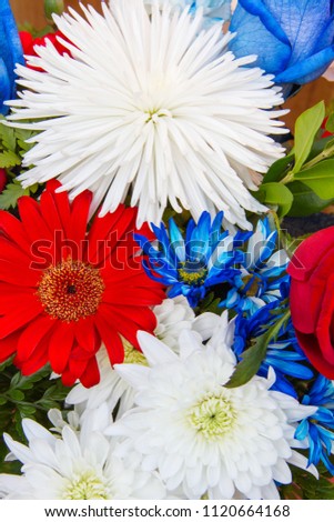Close up of bouquet of Red White and Blue Patriotic Labor Day Flowers, Red Barberton Gerbera Daisy, white chrysanthemum