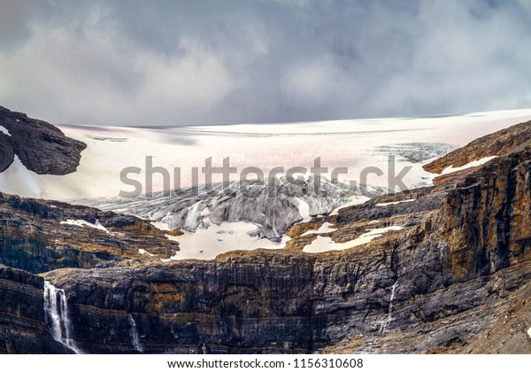 Close up of Bow Glacier with waterfalls in Banff\
National Park. Bow Glacier is an outflow glacier from the Wapta\
Icefield along the Continental Divide, and glacier runoff supplies\
water to Bow Lake.