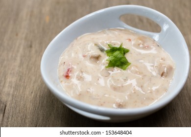 Close up of a bowl of creamy clam dip for chips and spreads.