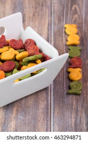 Close Up Of Bowl With Goldfish Crackers On A Wooden Background.