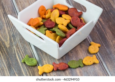 Close Up Of Bowl With Goldfish Crackers On A Wooden Background.