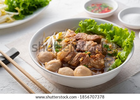 Close up of a bowl of Thai Braised pork Noodle Soup.