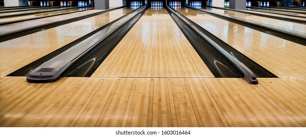 Close up of bowling balls, bowling pins bowling balls in a row.