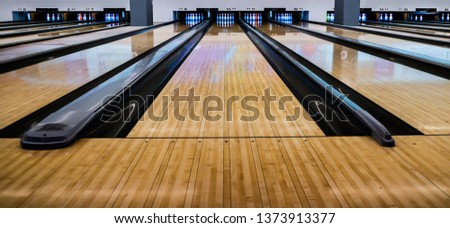 Close up of bowling balls, bowling pins bowling balls in a row.