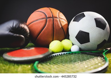 Close up of boxing gloves and basketball football tennis golf balls and discus - Powered by Shutterstock