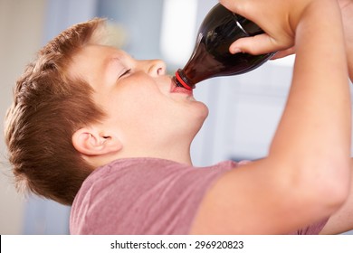 Close Up Of Boy Drinking Soda From Bottle