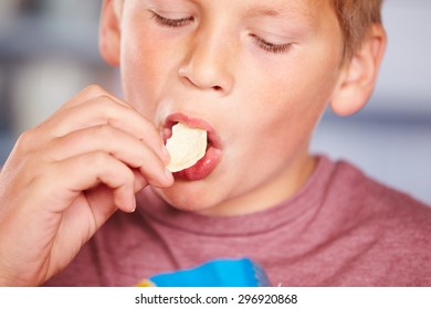 Close Up Of Boy Eating Packet Of Potato Chips