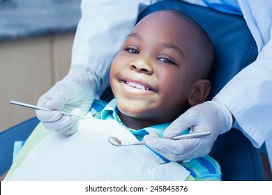 Close up of boy having his teeth examined by a dentist - Powered by Shutterstock