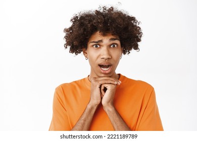 Close Up Of Boy Looking Worried And Concerned, Expression Compassion, Standing Over White Studio Background