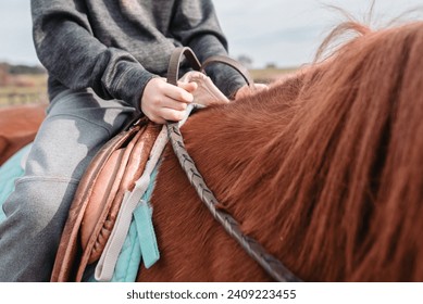 Close up of boy on horseback holding reins in hands - Powered by Shutterstock