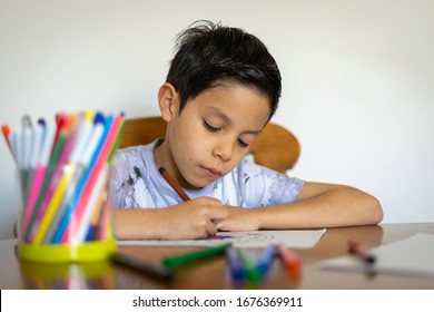 Close up of boy painting a mandala with his colored markers - Powered by Shutterstock