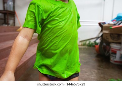 Close Up Boy Playing With Water, Detail Of Wet Dirty Green Shirt.