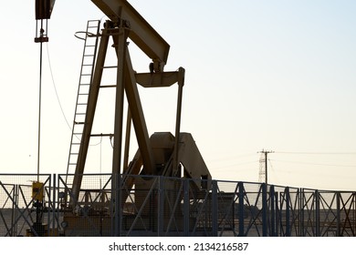 Close Up Of BPU Crude Oil Pump Beam At The Oilfield At Sunset - Selective Focus