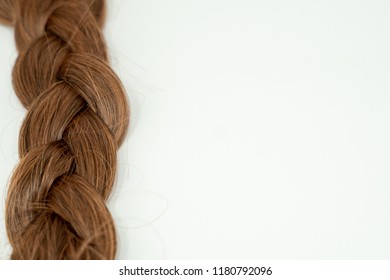 Close up of a braided hairstyle (brown brunette hair) isolated  white background. - Shutterstock ID 1180792096