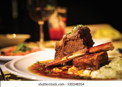 Close up of braised beef short rib on dinner table. Selective focus.

