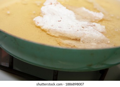 Close Up Of Breaded Chicken Strips Frying In A Pan