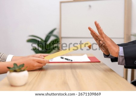 Close Up Of Bribe Rejection Envelope is Offered But Hand Signals "No"