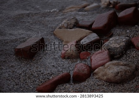 Close Up of Bricks and Rocks on the Beach 