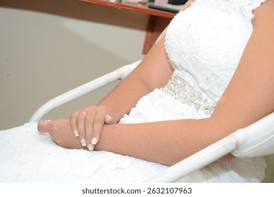 close up of a bride, making of bride, bride's hands, painted nails, hands close up, close up of hands signing marriage contract at outdoor wedding ceremony
