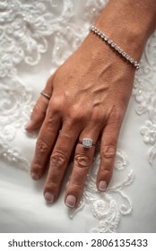 Close up of bride wearing diamond ring and bracelet.