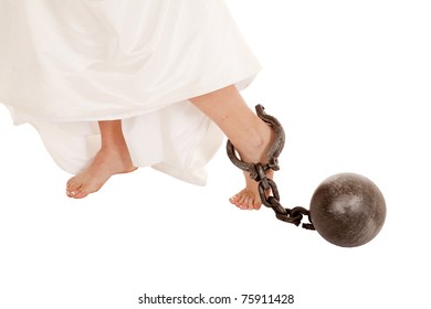 A Close Up Of A Bride's Bare Feet With A Ball And Chain Hooked On Her Ankle