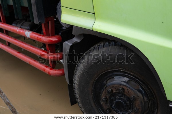 close up of bright colored dump truck tires.\
side view front and rear truck\
bumper