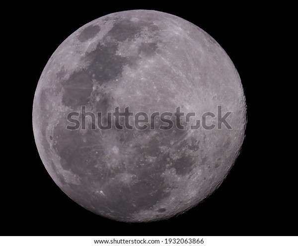 Close up of a bright full moon on the dark\
night, Big full moon on black\
background.