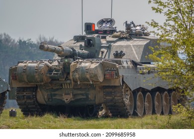 Close Up Of A British Army Challenger 2 FV4034 Main Battle Tank On A Military Exercise With Gun Facing Rearwards Over External Fuel Tanks, Wiltshire UK