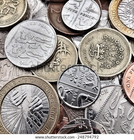 Close up of British Coins including bronze and silver, pound coins, pence and pennies. Creative filters and textures have been applied for effect