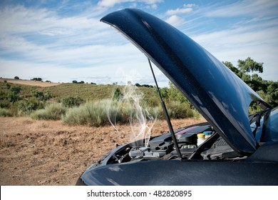 Close Up Of A Broken Down Car, Engine Open With Smoke, In A Rural Area