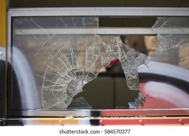 Close Up of Broken Glass Window on Graffitied Bus - Powered by Shutterstock