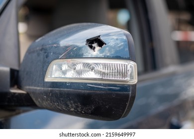 Close up broken left side rearview mirror of a car in blue. Auto insurance concept. Broken side glass of the car on the driver's side as a result of an accident. Criminal incident