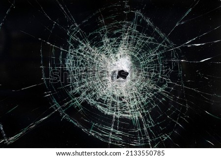 Close up of a broken shattered glass on a car windshield.
