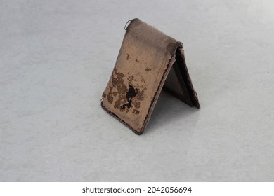 Close Up Of Broken Wallet On White Floor Background.