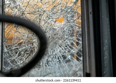 close up of broken windows on old school bus at scrap yard