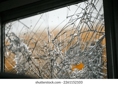 close up of broken windows on old school bus at scrap yard