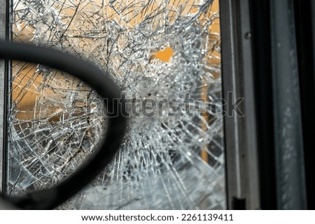close up of broken windows on old school bus at scrap yard