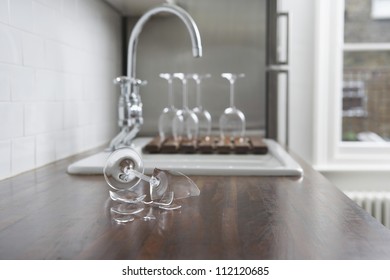 Close Up Of Broken Wine Glass On Kitchen Desk