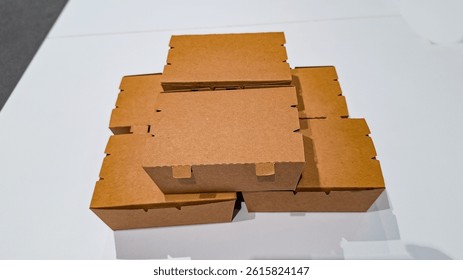 Close up of brown, rectangular cardboard box. pile of Eco friendly disposable salad food packing fruit kraft paper box isolated on white background. Top side view.