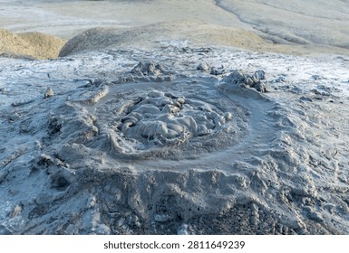 Close up of bubbling active mud volcano in geothermal area