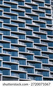 Close up building facade with repetitive pattern. Abstract architectural design with many windows for urban city development concept.